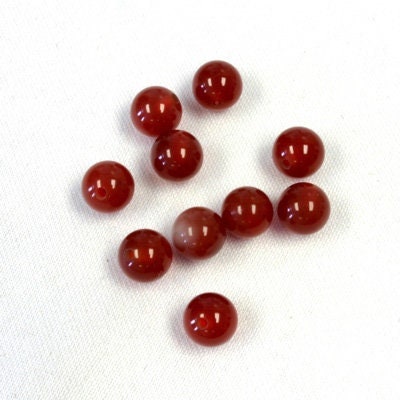 Half drilled natural carnelian beads, sold by the pair