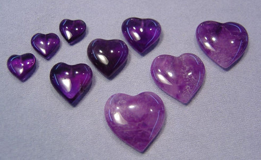 Natural amethyst hearts. Half-drilled. Available in three sizes.